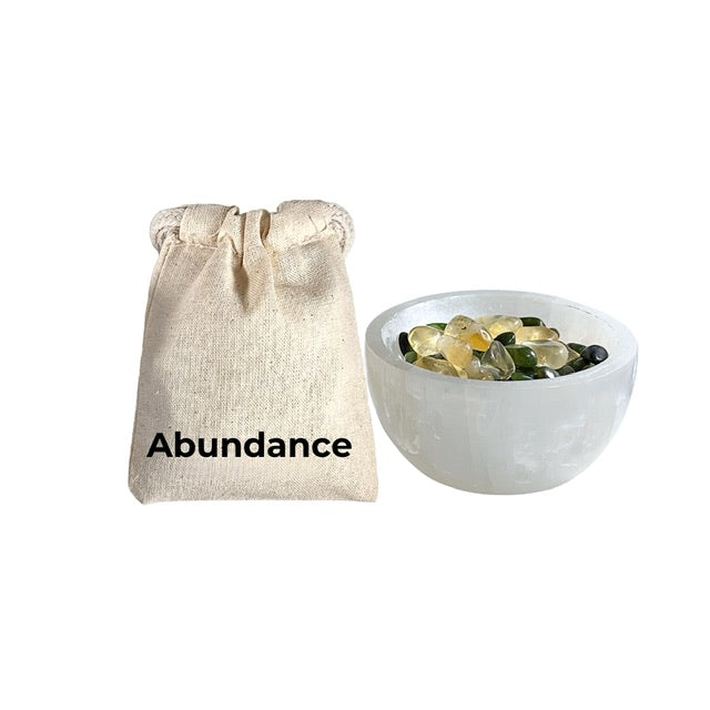 Abundance Pouch and a selenite bowl filled with; citrine, nephrite jade and pyrite crystals chips for abundance.