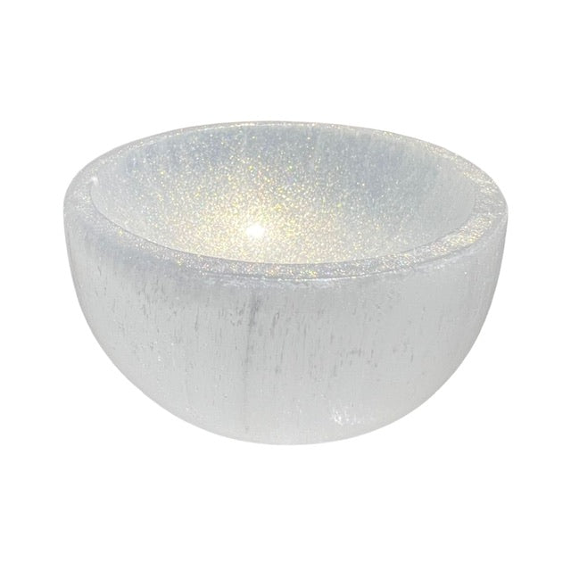 The top view of a medium sized selenite crystal bowl, hand adorned with shimmering gold, fairy dust.