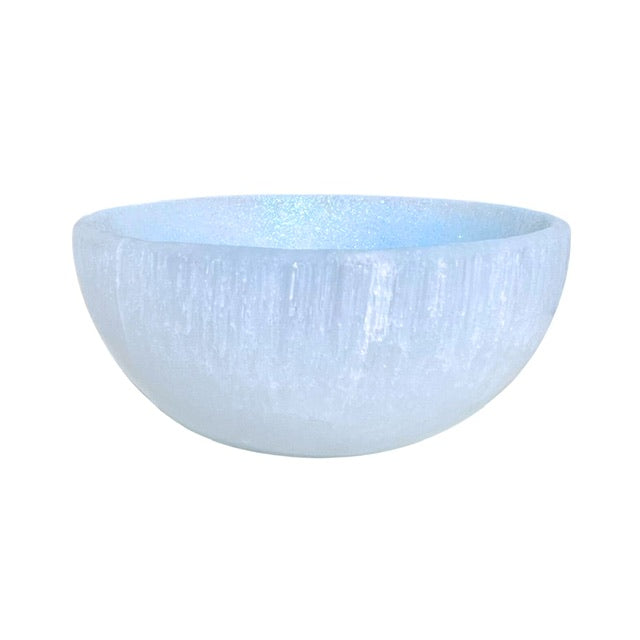 A large shimmering selenite crystal bowl, hand adorned with a sky blue finish.