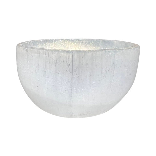 A selenite crystal bowl, hand adorned with shimmering gold, fairy dust.