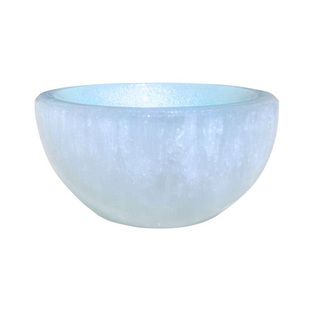 A petite selenite crystal bowl, hand adorned with a sky blue finish.