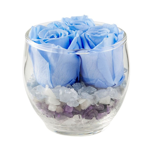 The Blooming Crystal Tranquility Vaz has layers of celestite, rainbow moonstone, amethyst, selenite and clear quartz crystals, topped with dreamy blue ForeverFloret preserved roses. 