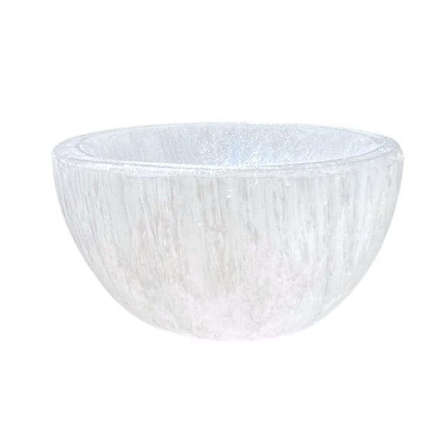 The side view of a petite selenite crystal bowl, hand adorned with a custom opalescent finish.