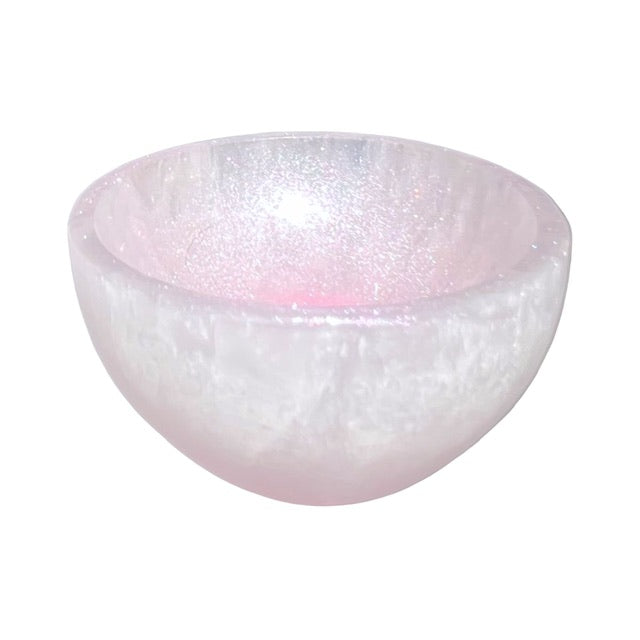 A view of the inside of a petite selenite crystal bowl, hand-painted  with a shimmering pink finish.