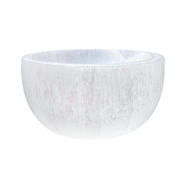 The side view of a shimmering ,selenite crystal bowl, hand painted with a custom opalescent finish.