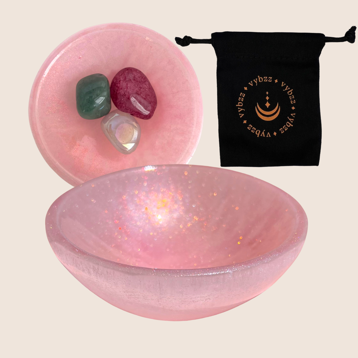Soft ruby tinted selenite crystal bowl, side view and top view with crystals and carry pouch.