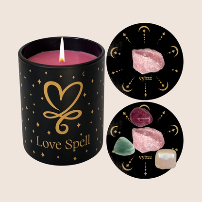 Love Spell aromatherapy candle with gold heart design and healing crystals displayed on black mats.
