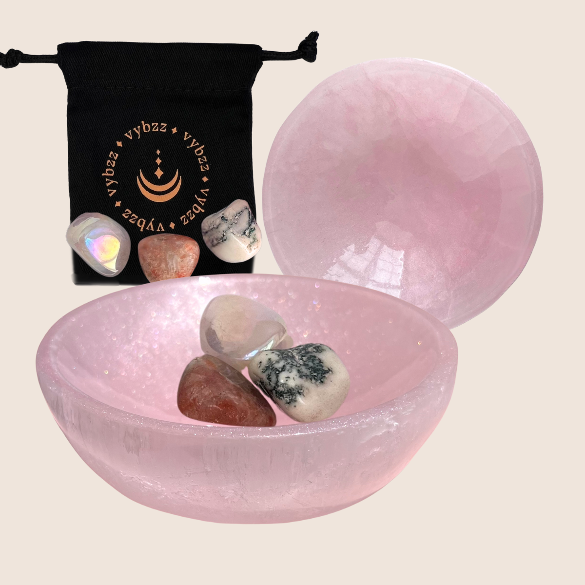 Two blush tinted selenite crystal bowls with sunstone, angel aura and tree agate crystals with carry pouch.