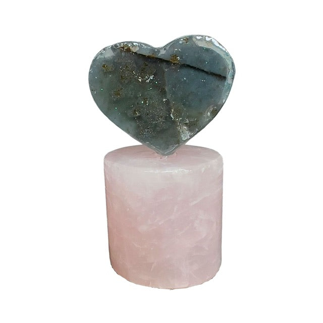 The back side of a petite amethyst heart crystal, placed atop a rose quartz pedestal. Both crystals are from Uruguay.  