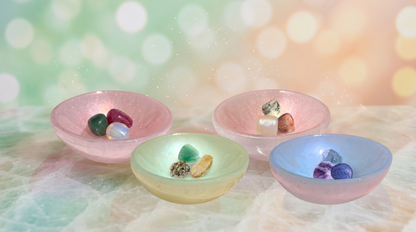 Four hand-tinted selenite bowls, each holding three curated crystals representing the Love Spell, Channel Prosperity, Soul Soothing, and Infinite Zen intentions.