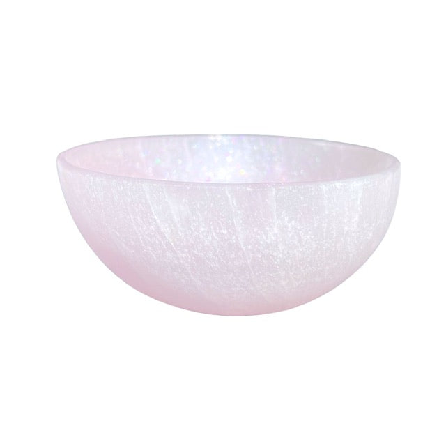 A medium sized selenite crystal bowl, featuring a hand-painted shimmering pink finish.