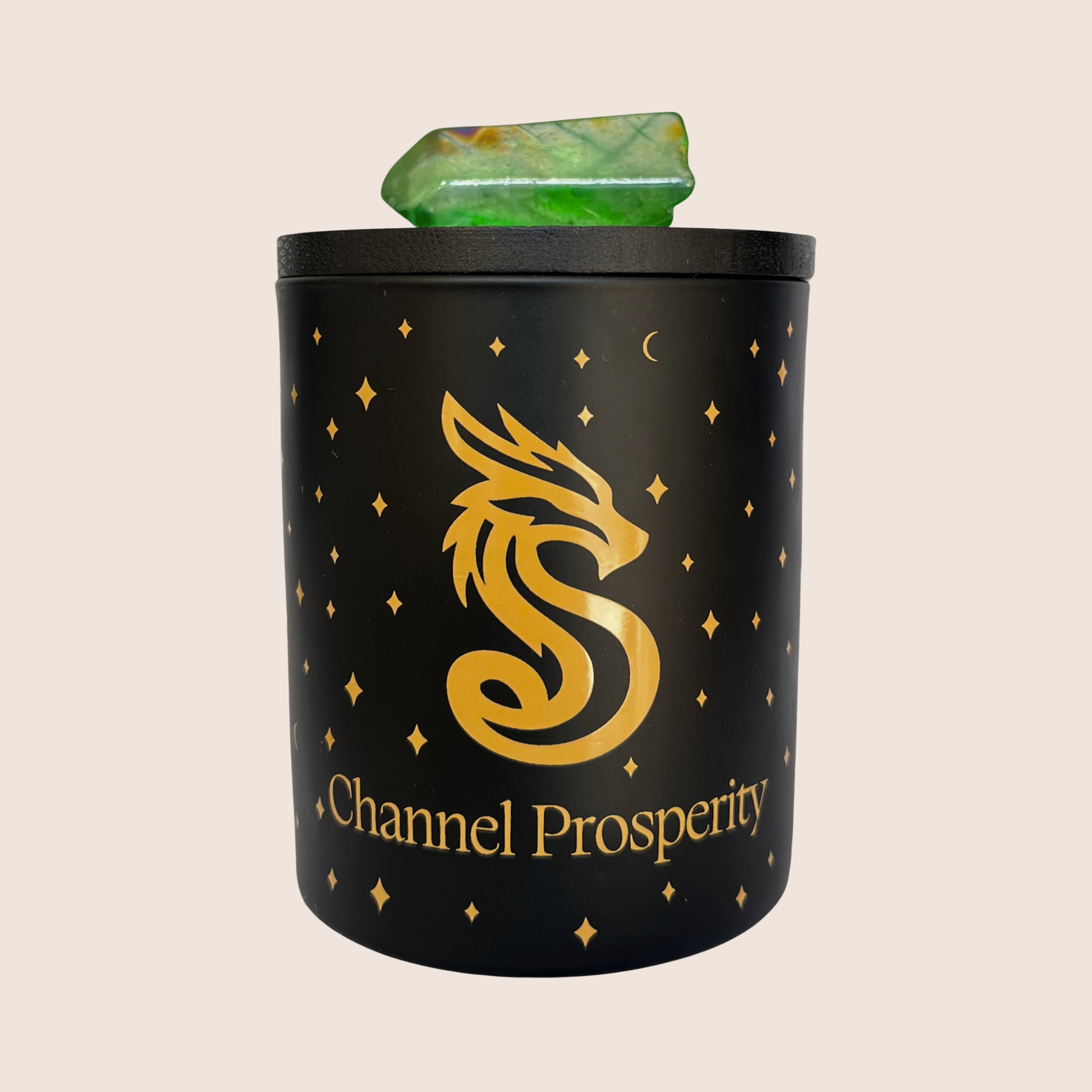 Matt black branded Channel Prosperity Intention candle with a gold dragon icon, featuring a lavender and yellow aura crystal on the candle lid.