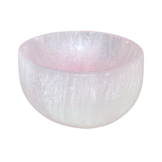 The top view of a selenite crystal bowl, featuring a hand-painted shimmering pink finish.