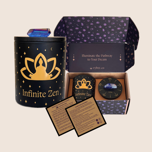 Intention Illuminating Infinite Zen soy candle set with blue aura crystal on lid, branded gift box, and product care cards.