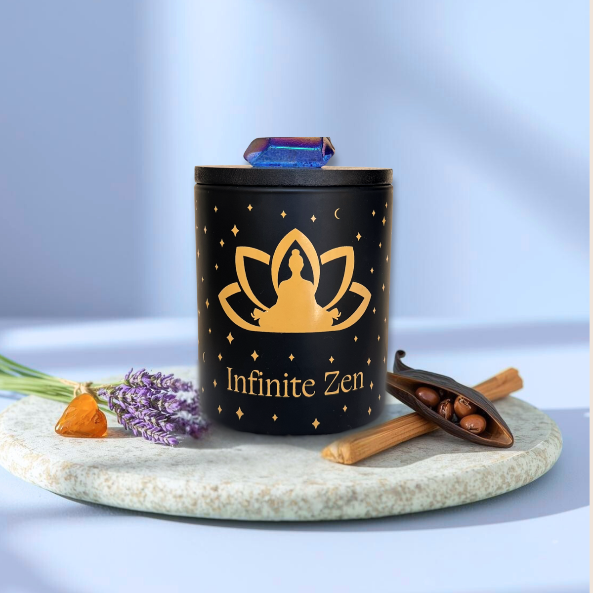 Infinite Zen aromatherapy candle with gold icon of meditation figure, vanilla bean pod, sandalwood, lavender sprig, and amber.