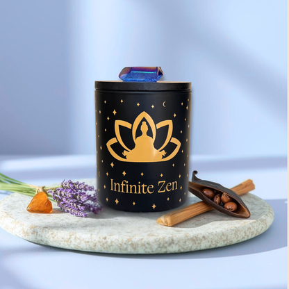 Black aromatherapy candle labeled Infinite Zen with crystal, lavender, crystal stone, and vanilla bean on a stone tray.