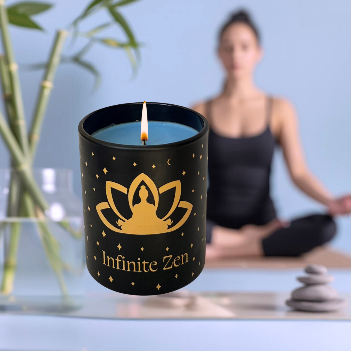 Infinite Zen lit candle in black branded jar, with bamboo stems and person meditating in blurred background.