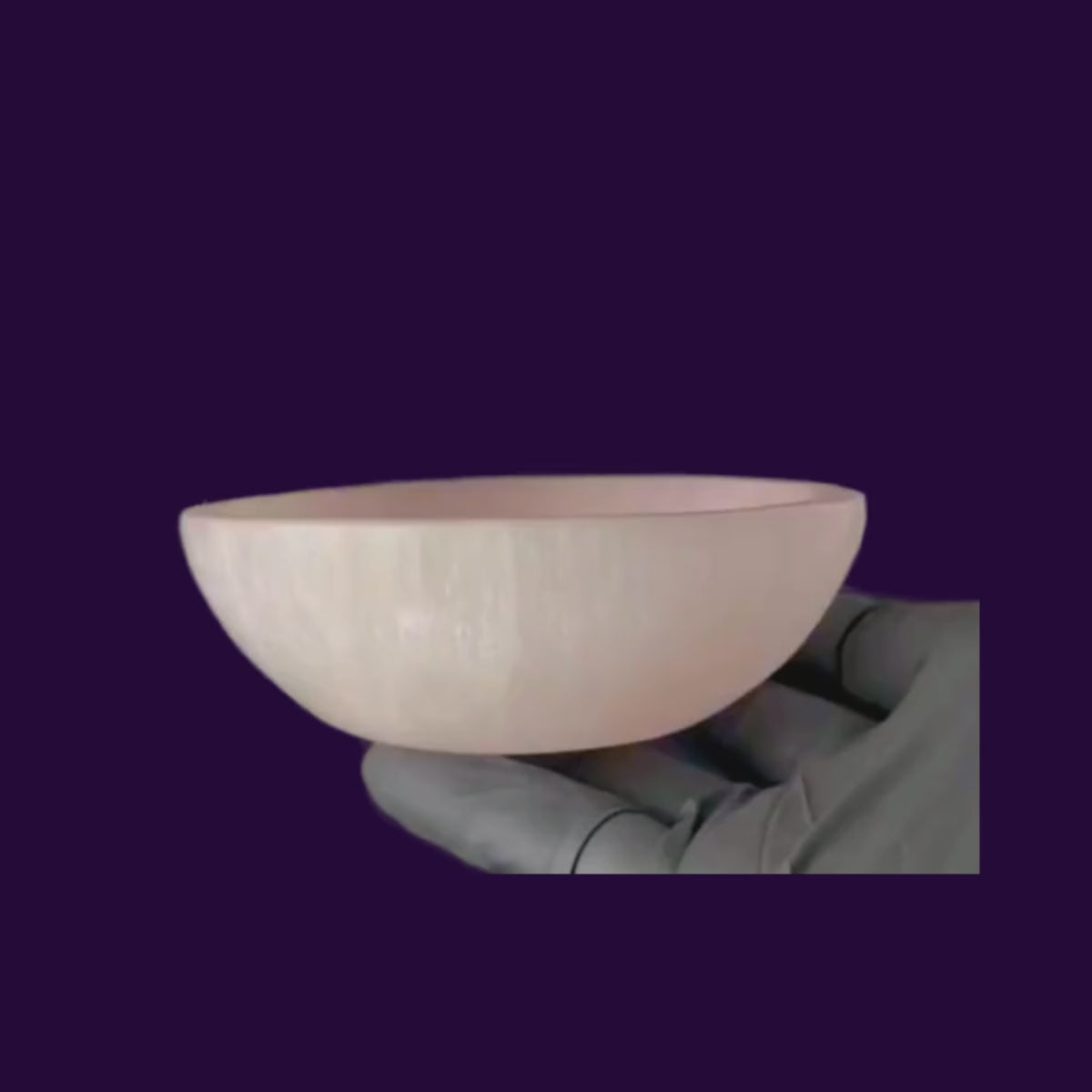 A video of a shimmering red blush selenite crystal bowl