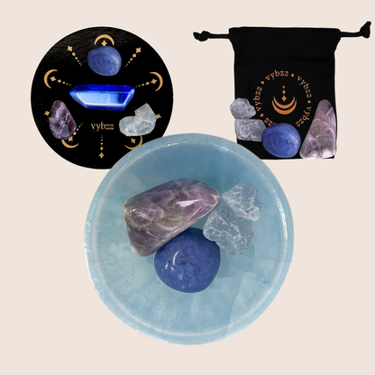 Blue selenite bowl with healing crystals, crystal pouch, and decorative lid for manifestation kits.